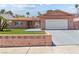 Single-story home with a spacious driveway, two-car garage, and well-maintained artificial lawn at 4115 Ridgewood Ave, Las Vegas, NV 89120