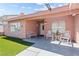 Charming single-story home featuring a well-manicured lawn and a cozy front porch seating area at 4115 Ridgewood Ave, Las Vegas, NV 89120
