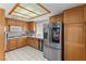 Updated kitchen features stainless steel appliances, natural wood cabinets, and modern decor at 4115 Ridgewood Ave, Las Vegas, NV 89120