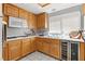 Modern kitchen features stainless steel appliances, wood cabinets, and wine cooler at 4115 Ridgewood Ave, Las Vegas, NV 89120
