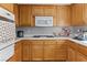 Cozy kitchen features wood cabinetry, white countertops, and appliances at 4115 Ridgewood Ave, Las Vegas, NV 89120
