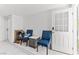 Inviting room featuring comfortable blue chairs, a stylish marble table, and an easy-access doorway at 4115 Ridgewood Ave, Las Vegas, NV 89120