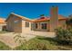 Back of the home with sliding glass doors to the backyard and an adjacent concrete patio at 4336 Fenton Ln, North Las Vegas, NV 89032