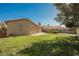 Spacious backyard featuring a lush lawn, perimeter landscaping, block wall fencing, and patio area at 4336 Fenton Ln, North Las Vegas, NV 89032