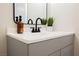 Close-up of the bathroom vanity with quartz countertop, modern fixtures, and decorative greenery at 4336 Fenton Ln, North Las Vegas, NV 89032