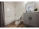 Clean bathroom with tile shower over tub, grey vanity, modern fixtures, and wood-look vinyl flooring at 4336 Fenton Ln, North Las Vegas, NV 89032