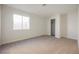 Bright and spacious bedroom with neutral carpet, baseboards, and trim, adjacent to a closet at 4336 Fenton Ln, North Las Vegas, NV 89032