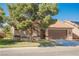 Charming single-story home with a low-pitched roof, a two-car garage, and mature landscaping at 4336 Fenton Ln, North Las Vegas, NV 89032