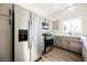 Kitchen with stainless steel refrigerator, modern appliances, gray cabinetry, and natural light at 4336 Fenton Ln, North Las Vegas, NV 89032