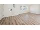 Bright and airy living room with light wood floors and freshly painted walls at 4336 Fenton Ln, North Las Vegas, NV 89032