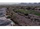 Panoramic aerial shot showcasing the golf course, nearby homes, and mountain views in the distance at 437 Pinnacle Heights Ln, Las Vegas, NV 89144