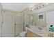 Bright bathroom featuring a shower with glass door, single sink, and vanity with neutral countertops at 437 Pinnacle Heights Ln, Las Vegas, NV 89144