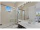 Bright bathroom with a shower-over-tub combination featuring a glass enclosure and neutral tile at 437 Pinnacle Heights Ln, Las Vegas, NV 89144