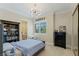 Well-lit bedroom with a modern light fixture, dark wood furniture, and a serene atmosphere at 437 Pinnacle Heights Ln, Las Vegas, NV 89144