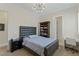 Comfortable bedroom with a padded headboard, a reading nook, and a modern light fixture at 437 Pinnacle Heights Ln, Las Vegas, NV 89144