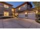 Home exterior with a spacious three-car garage, concrete driveway, and manicured landscaping at 437 Pinnacle Heights Ln, Las Vegas, NV 89144