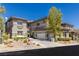 Stylish two-story home with a three-car garage, desert landscaping, and a well-manicured yard at 437 Pinnacle Heights Ln, Las Vegas, NV 89144