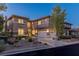 Beautiful home exterior featuring a three-car garage, landscaped yard, and driveway at 437 Pinnacle Heights Ln, Las Vegas, NV 89144