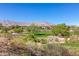 Scenic view of a lush golf course surrounded by desert landscaping, buildings, and distant mountains at 437 Pinnacle Heights Ln, Las Vegas, NV 89144