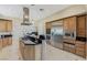 Gourmet kitchen with stainless steel appliances, granite countertops, and custom cabinetry at 437 Pinnacle Heights Ln, Las Vegas, NV 89144