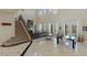 Spacious living room featuring a staircase, fireplace, tile floors, and natural light at 437 Pinnacle Heights Ln, Las Vegas, NV 89144