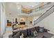 Spacious living room boasts staircase, dining area, and elegant chandelier lighting at 437 Pinnacle Heights Ln, Las Vegas, NV 89144
