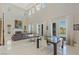 Open living room with fireplace, high ceilings, natural light, tile floors, and dining area at 437 Pinnacle Heights Ln, Las Vegas, NV 89144