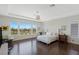 Bright main bedroom with golf course views, wood floors, and elegant furnishings at 437 Pinnacle Heights Ln, Las Vegas, NV 89144