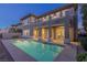 Home's backyard featuring an in-ground pool and a covered outdoor living space at 437 Pinnacle Heights Ln, Las Vegas, NV 89144