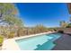 Inviting backyard pool with lush landscaping, wrought iron fence and views of the golf course at 437 Pinnacle Heights Ln, Las Vegas, NV 89144
