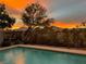 Backyard pool view showcasing desert landscape and beautiful sunset over the mountains at 437 Pinnacle Heights Ln, Las Vegas, NV 89144