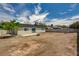 Rear view of the home with a spacious backyard, block wall and blue sky at 4387 Sun Vista Dr, Las Vegas, NV 89104