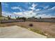 Expansive backyard space with clear skies, surrounded by trees, and a concrete block wall at 4387 Sun Vista Dr, Las Vegas, NV 89104