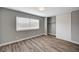 This bedroom features wood floors, a window with blinds, and a closet at 4387 Sun Vista Dr, Las Vegas, NV 89104