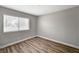 This bedroom features wood floors, neutral paint, and a window with blinds at 4387 Sun Vista Dr, Las Vegas, NV 89104