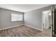 This bedroom features wood floors, neutral paint, and a view of the ensuite at 4387 Sun Vista Dr, Las Vegas, NV 89104