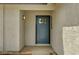 Close-up of the front door with decorative glass and a modern light fixture, set in a stucco facade at 4387 Sun Vista Dr, Las Vegas, NV 89104