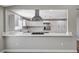 Open-concept kitchen featuring stainless steel appliances, white cabinets, quartz countertops, and a center island at 4387 Sun Vista Dr, Las Vegas, NV 89104