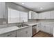 Modern kitchen with marble countertops, stainless steel dishwasher, and white shaker cabinets at 4387 Sun Vista Dr, Las Vegas, NV 89104