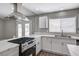 Bright kitchen with stainless steel appliances, white cabinetry, and a double sink under a window at 4387 Sun Vista Dr, Las Vegas, NV 89104
