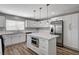 Open kitchen featuring an island with stainless steel microwave, white cabinets, and stainless refrigerator at 4387 Sun Vista Dr, Las Vegas, NV 89104