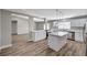 Bright kitchen features white cabinets, stainless steel appliances and a center island with quartz countertops at 4387 Sun Vista Dr, Las Vegas, NV 89104
