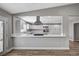 Bright open kitchen with white cabinets, stainless steel appliances, an island, and quartz countertops at 4387 Sun Vista Dr, Las Vegas, NV 89104