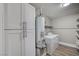Functional laundry room with storage, washer, dryer, water heater and wood-look floors at 4387 Sun Vista Dr, Las Vegas, NV 89104