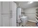 Laundry room with shelving, washer, dryer, and storage cabinets at 4387 Sun Vista Dr, Las Vegas, NV 89104