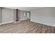 Open floor plan with wood-look floors, fireplace, wainscotting, and fresh paint at 4387 Sun Vista Dr, Las Vegas, NV 89104