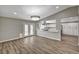 Open-concept living area with wood floors, a modern light fixture, and access to the kitchen and French doors at 4387 Sun Vista Dr, Las Vegas, NV 89104