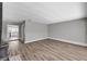 Open floor plan with wood-look floors and vintage-style fireplace with brick hearth at 4387 Sun Vista Dr, Las Vegas, NV 89104