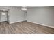 Spacious living area featuring wood floors, neutral walls, and a modern light fixture at 4387 Sun Vista Dr, Las Vegas, NV 89104