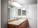 Well-lit bathroom featuring a granite countertop, wood cabinets and a large mirror at 4400 S Jones Blvd # 2075, Las Vegas, NV 89103